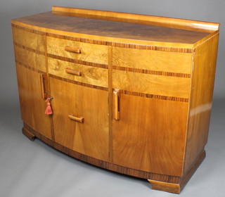 An Art Deco figured walnut bow front sideboard with raised back, fitted 2 long drawers above a cupboard and flanked by a pair of cupboards, raised on bracket feet 38"h x 54"w x 23"d 