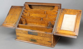 An Edwardian wedge shaped oak stationery box, the base incorporating a writing slope, the hinge marked Emanuel & Sons 14"h x 16"w x 12"d 