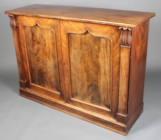 A Regency mahogany chiffonier enclosed by a pair of arched panelled doors having columns to the sides with flowerhead capitals, raised on a platform base 38"h x 54"w x 17 1/2"d 
