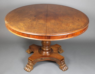 A circular Victorian mahogany snap top dining table, raised on turned column and triform base, paw feet 29"h x 46" diam. 