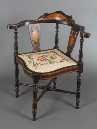 An Edwardian inlaid mahogany corner chair with Berlin woolwork seat on turned supports with X framed stretcher 