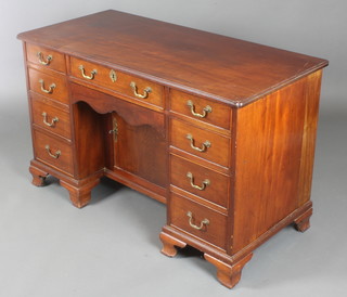 An 18th/19th Century mahogany kneehole pedestal desk/dressing table fitted 1 long drawer above a secret drawer, the pedestal fitted a cupboard enclosed by panelled doors, flanked by 8 short drawers, raised on bracket feet 29 1/2"h x 48"w x 22"d 