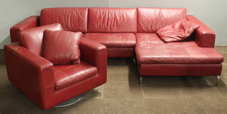 Natuzzi, a chrome framed and red leather upholstered corner sofa together with a swivel armchair 