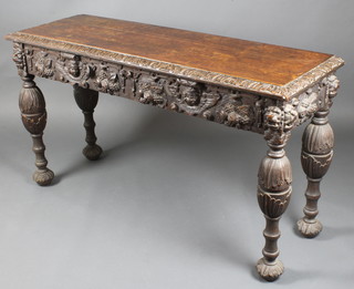 A 19th Century carved southern German oak serving table, the apron carved masks and fruit, raised on bulbous turned cup and cover supports 30"h x 54"w x 18"d 