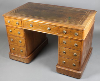 A Victorian oak kneehole desk with brown inset writing surface above 1 long and 8 short drawers with brass ring drop handles 30"h x 48"w x 28" 