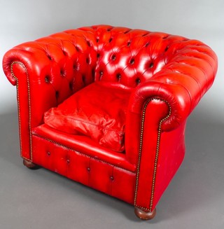 A Chesterfield armchair upholstered in red buttoned back leather 