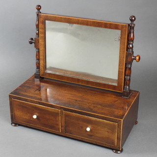 A 19th Century rectangular plate dressing table mirror contained in a mahogany swing frame, the base fitted 2 drawers with ivory handles, raised on bun feet 16"h x 18"w x 9"d 