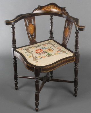 An Edwardian inlaid mahogany corner chair with Berlin woolwork seat raised on turned supports with X framed stretcher 