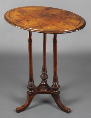 A Victorian oval figured walnut occasional table with quarter veneered top, raised on turned supports with triform base 27"h x 23"w x 17 1/2"d 
