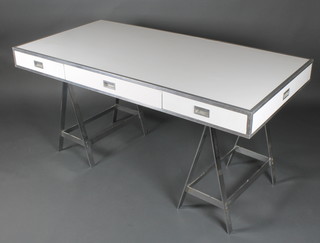 Alessandro Albrizzi, a 1970's white laminate and polished aluminium campaign style trestle writing table fitted 2 short and 1 long drawers 31"h x 61"w x 30"d 