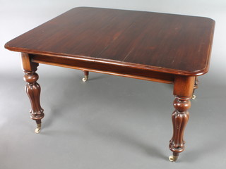 A Victorian mahogany extending dining table, raised on turned and fluted supports with 2 extra leaves 27"h x 48"w x 40" x 61 1/2" when extended