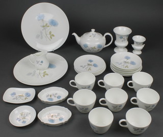 A Wedgwood Ice Rose tea set comprising 7 tea cups, 7 saucers a tea pot, cream jug, sugar bowl, and 5 side plates, 4 dishes, 2 vases and 2 large plates 