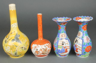 A pair of early 20th Century Imari oviform vases with wavy rims decorated with figures in pavilions 6 1/4" and 2 bottle vases