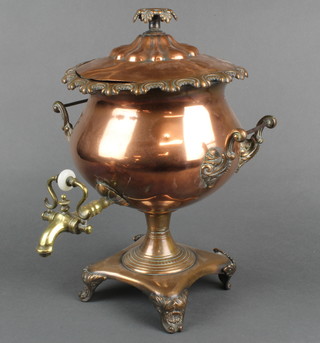 A Georgian twin handled copper tea urn, raised on shell panelled supports 16"h 