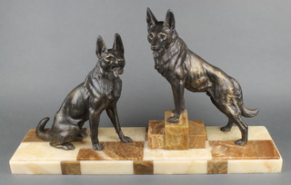 L Carvin, an Art Deco bronze and marble figure group of 2 German Shepherds, raised on a 2 colour marble base 17"h x 28"w x 7"d 