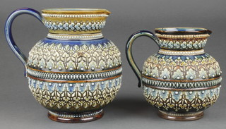 Two Doulton Lambeth jugs with moulded leaf decoration both stamped 1884 5 1/4" and 6 1/4" 