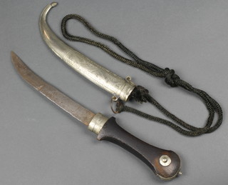 A white metal Arab dagger with hardwood handle