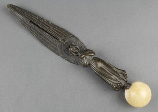 An Art Nouveau bronze paper knife in the form of a standing angel, raised on a spherical marble terminal 