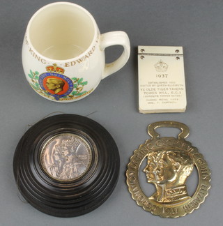 A 1937 black circular Clay Pigeon set a silver commemorative crown for the Coronation of George VI, a ditto brass horse brass and a ditto aide memoir advertising Ye Olde Tiger Tavern Tower Hill EC3 and a Myott Edward VIII Coronation mug 
