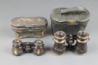 Two pairs of opera glasses in leather cases
