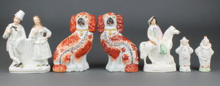 A pair of Victorian ochre Staffordshire spaniels 7 1/2" two Staffordshire groups and 2 clowns