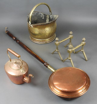 A 19th Century Maples & Co oval copper kettle 2", a pair of Art Nouveau brass fire dogs 8", a brass helmet shaped coal scuttle and a reproduction warming pan 