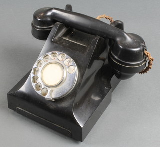 A black Bakelite dial telephone, the base marked FWR 61/2 