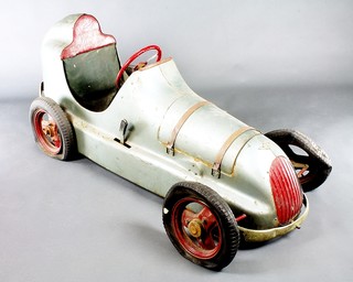 A good late 1940's Austin Pathfinder pressed steel pedal car, complete with detachable bonnet revealing a faux engine and 4 dummy spark plugs 63" long 22" wide to outer wheel, 23 1/2" high