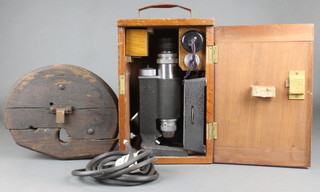A minocular single pillar electric microscope cased 