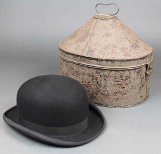A 19th Century oval pressed metal military hat box, a gentleman's grey top hat by Moss Bros and a pair of grey gloves and an Austen Reed lightweight bowler hat 
