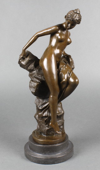 A bronze figure of a naked lady 16", raised on a socle base 