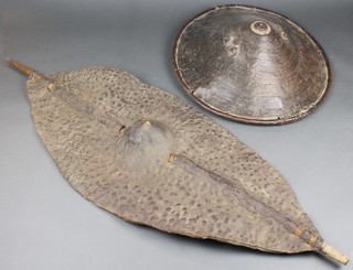 A 19th Century circular "African" hyde shield 21" together with an oval hyde shield 38" x 17"