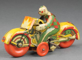 A British made early 20th century clockwork tin plate model of a clown riding a motor cycle 5" 