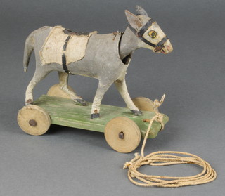 A child's 1930's carved and wooden figure of a nodding donkey 6" 

