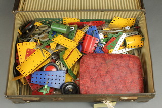 A collection of various yellow, green and blue Meccano contained in an attache case