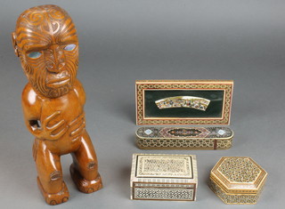 A Maori style carved wooden standing figure 13", a rectangular Persian style box with hinged lid 2"h x 5"w x 3"d, a hexagonal Persian style box 1"h x 4"w x 4"d, do. oval pencil box 1" x 8" x 2" and an easel frame 4" x 8 1/2" 
