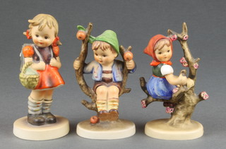 A Hummel Apple tree girl 141 3/0 4", Apple tree boy 142 3/0 4" and Girl with back pack 81 2/0 4"