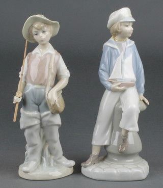 A Lladro figure of a boy fisherman 9" and a ditto of a boy with boat 8"