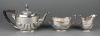 A Victorian silver 3 piece tea set with demi fluted decoration and ebony mounts, London 1896 gross  866g