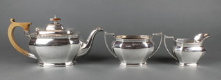 An Art Deco three piece silver tea set with fruitwood mounts, Sheffield 1937, gross weight 1203 grams