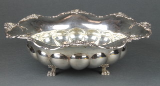 A continental 835 fancy fluted bowl with floral rim on claw feet. 9 1/2" 