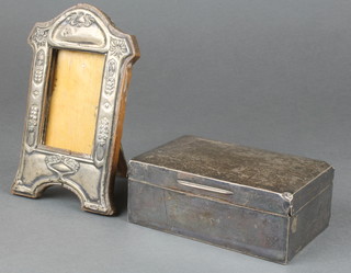 An Edwardian repousse silver photograph frame, Birmingham 1909 6" and a silver cigarette box 6"