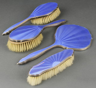 A silver and blue guilloche enamel 4 piece brush set comprising a hand mirror 2 hair and one clothes brush Birmingham 1929
