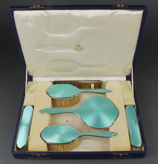 A silver and green guilloche enamel cased 6 piece dressing table set