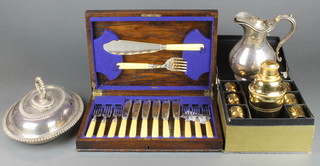 A silver plated oval entree set, a jug, cased fish eaters for 6 and a cocktail set