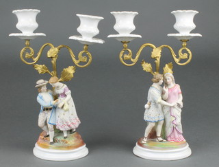 A pair of Continental bisque gilt mounted candelabra of courting couples 10"