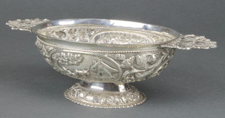 An Indian repousse silver 2 handled oval bowl decorated in the European style with cattle before farm buildings 10" 