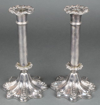 A pair of 19th Century silver plated repousse candlesticks 9"