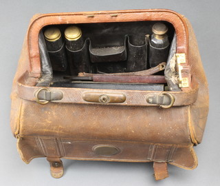 A leather toilet case containing 4 silver plated mounted bottles 
