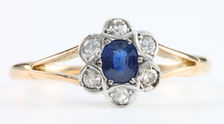 An 18ct yellow gold sapphire and diamond cluster ring Size K